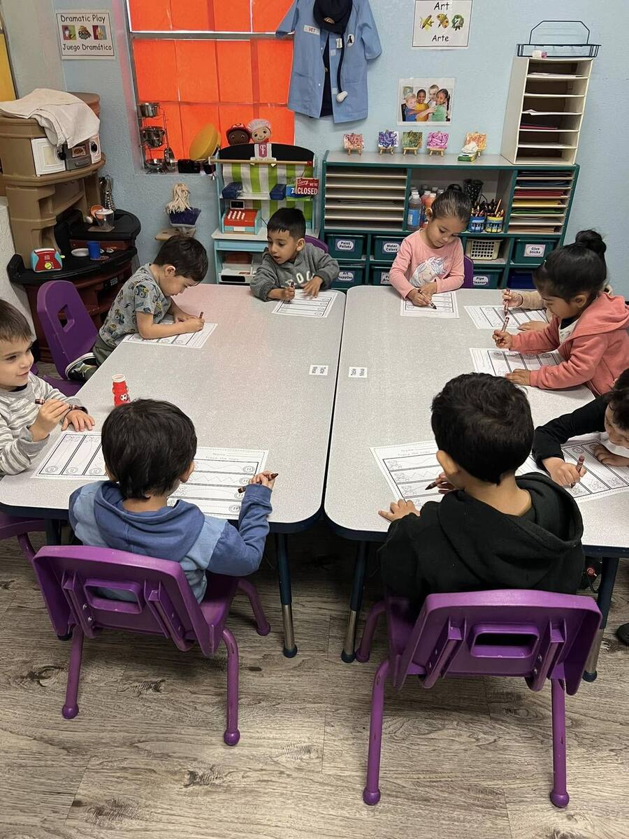 Preschoolers tracing lines at their tables