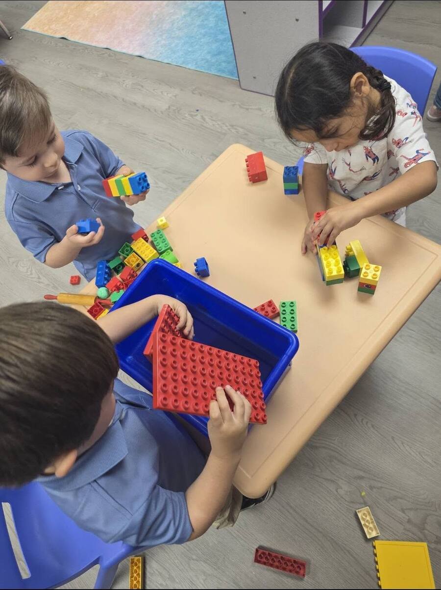 Children building together with large building bricks