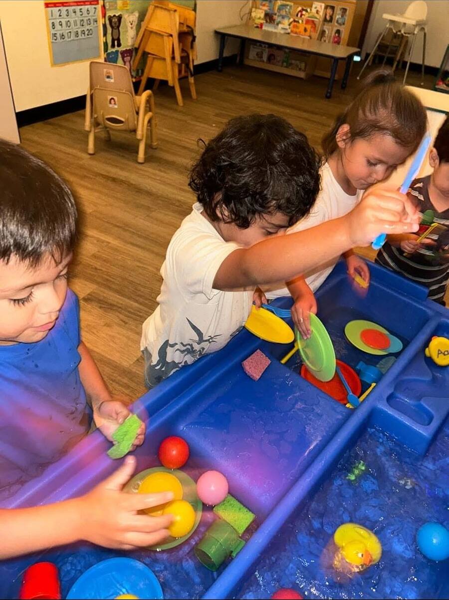Toddlers playing at the water table